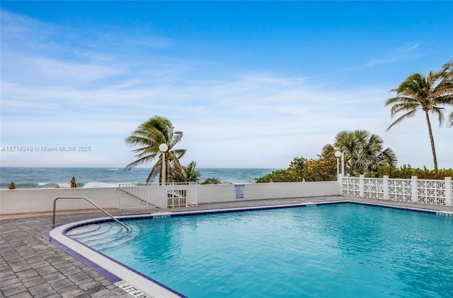 view of swimming pool featuring a water view