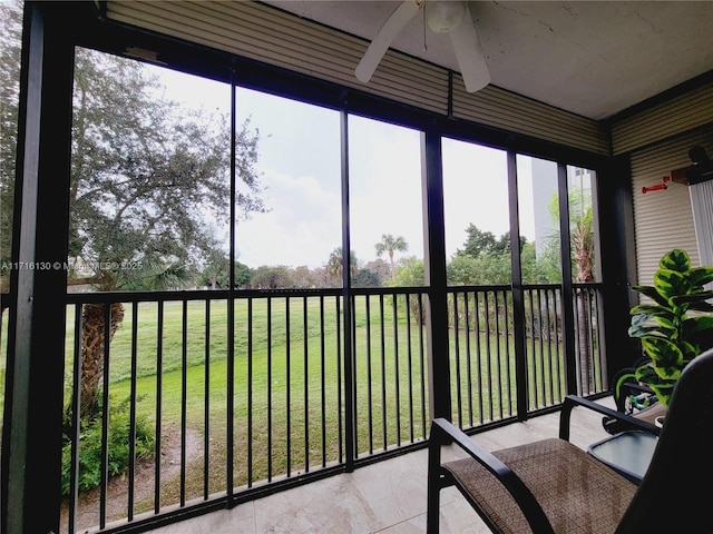 sunroom featuring ceiling fan and a healthy amount of sunlight