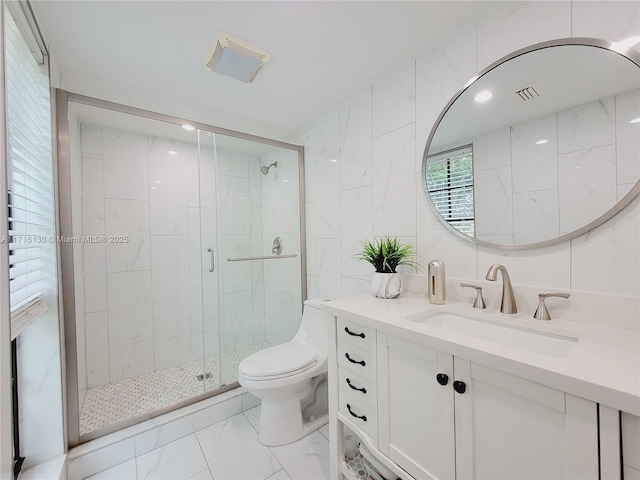 bathroom with walk in shower, vanity, tile walls, and toilet