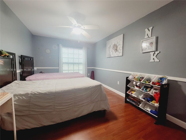 bedroom featuring ceiling fan and dark hardwood / wood-style flooring