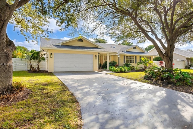 ranch-style house with a garage and a front lawn