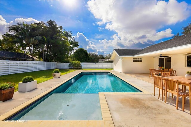 view of pool featuring ceiling fan, a patio area, and a yard