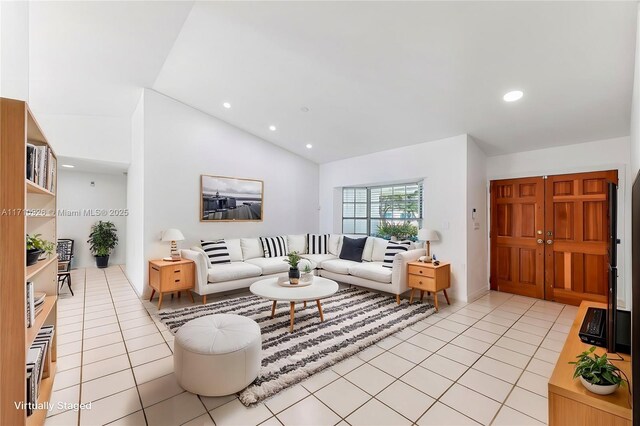 kitchen with kitchen peninsula, stainless steel electric range oven, sink, and light tile patterned floors