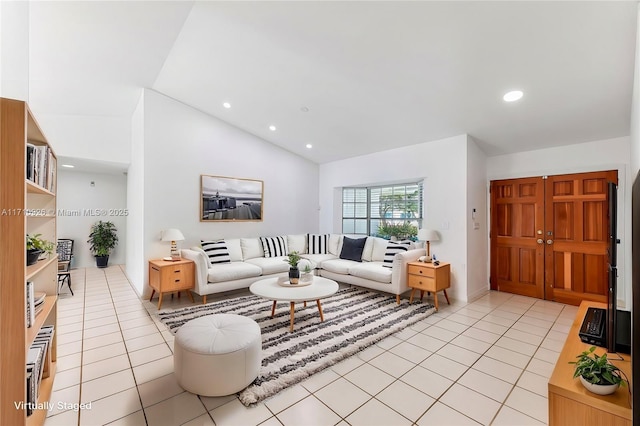 living room with lofted ceiling and light tile patterned floors