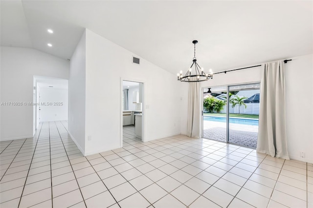 tiled empty room with high vaulted ceiling and an inviting chandelier