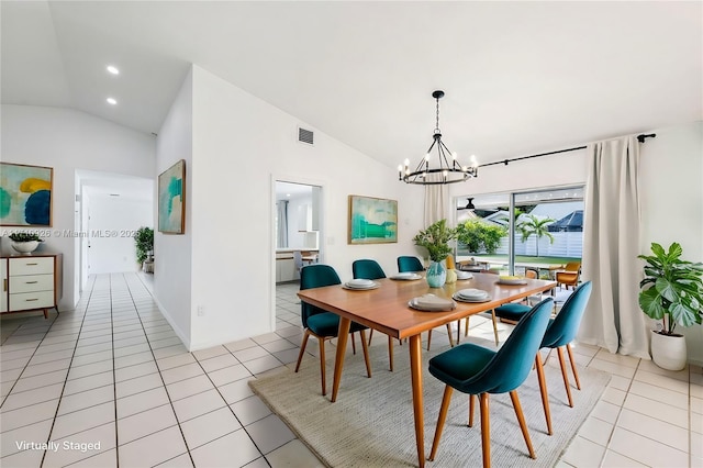 dining area featuring light tile patterned flooring, lofted ceiling, and a chandelier