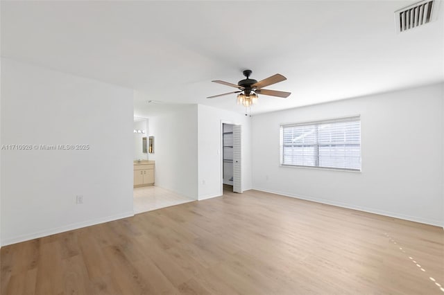 spare room featuring ceiling fan and light hardwood / wood-style floors