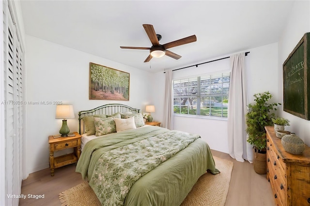 bedroom featuring ceiling fan and light hardwood / wood-style flooring