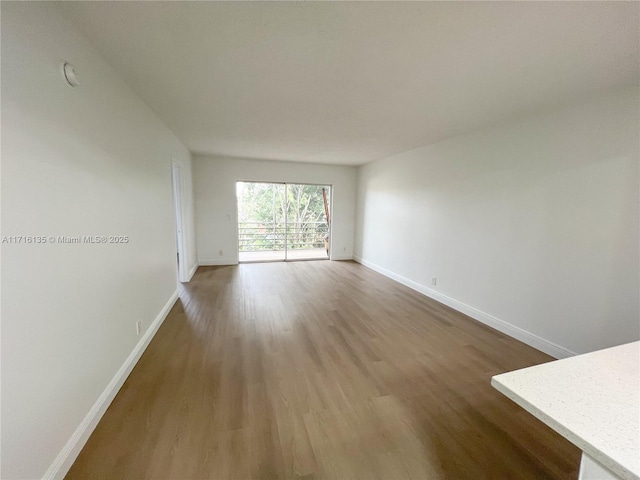 spare room with wood-type flooring