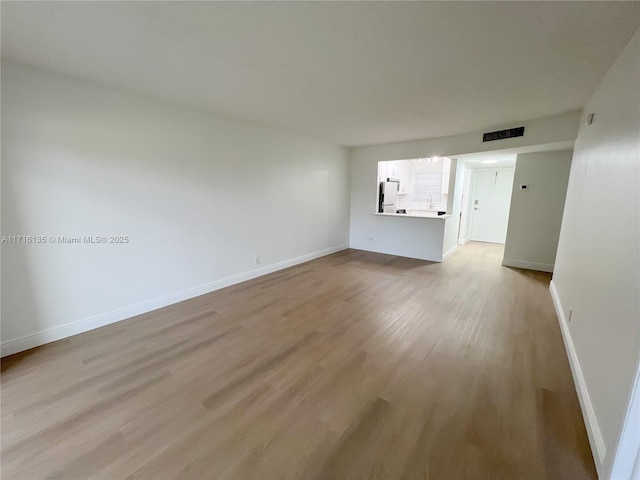 unfurnished living room featuring light hardwood / wood-style floors