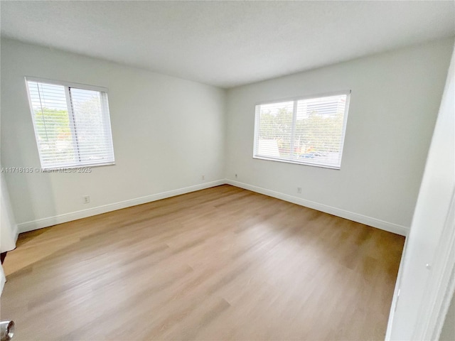 spare room with light hardwood / wood-style flooring