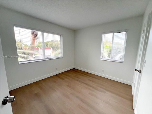 unfurnished room with light hardwood / wood-style floors