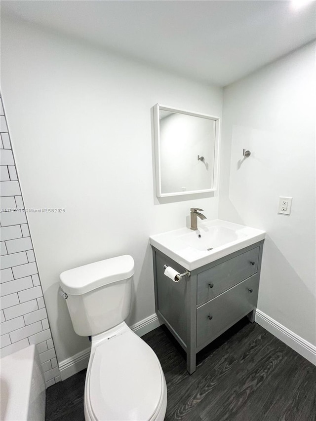 bathroom with vanity, wood-type flooring, and toilet