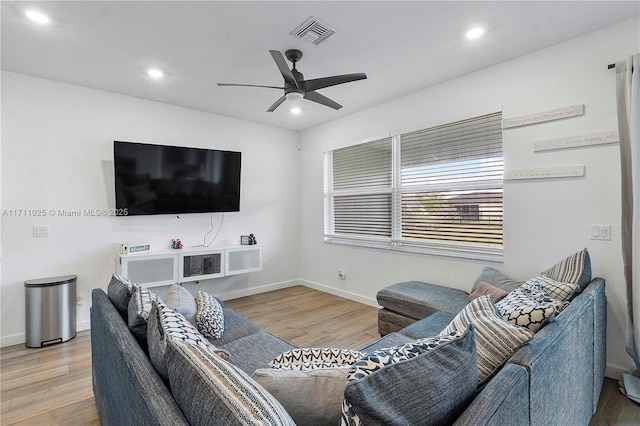 living room featuring light wood-type flooring and ceiling fan