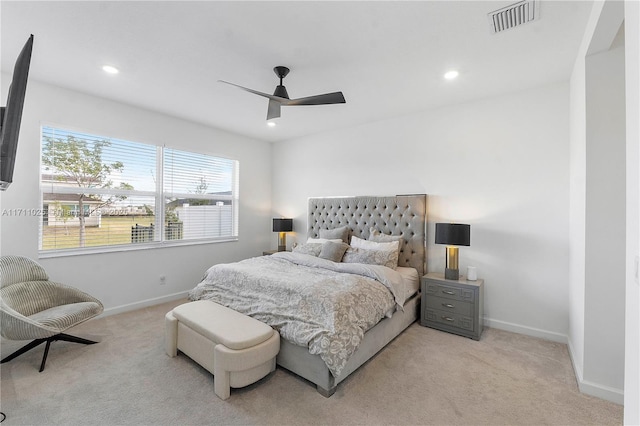 bedroom featuring light carpet and ceiling fan