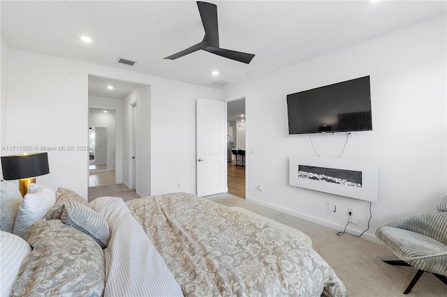 bedroom featuring light colored carpet and ceiling fan