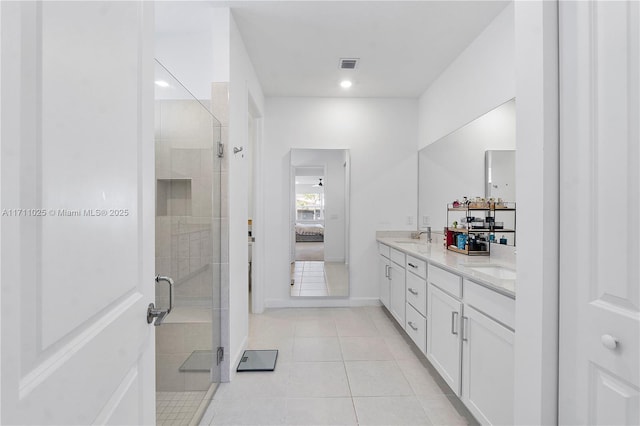 bathroom featuring tile patterned floors, vanity, and a shower with door