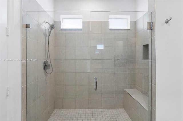 bathroom featuring a wealth of natural light and a shower with door