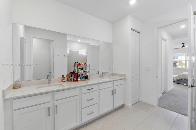 bathroom with tile patterned flooring, vanity, ceiling fan, and a shower with door