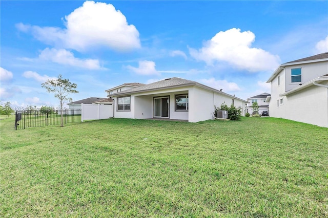 rear view of house with a lawn