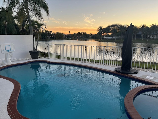 pool at dusk with a water view