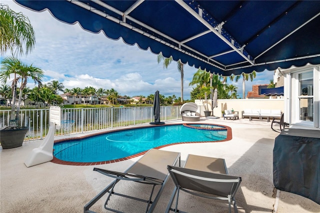 view of swimming pool featuring area for grilling and a patio