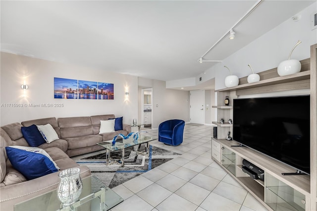 living room featuring light tile patterned floors and track lighting