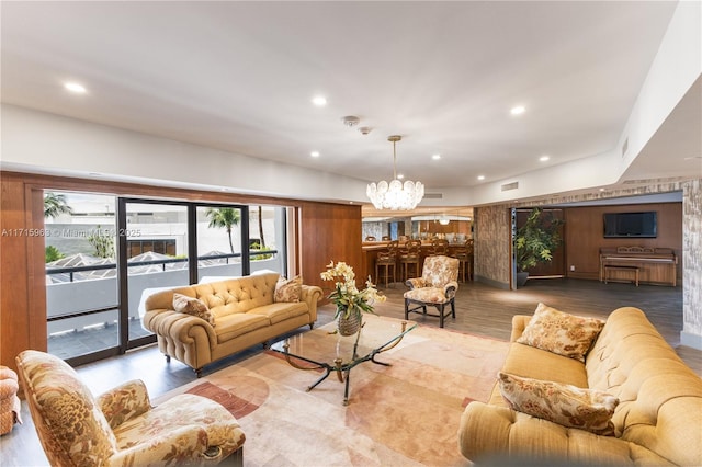 living room with hardwood / wood-style floors and a notable chandelier