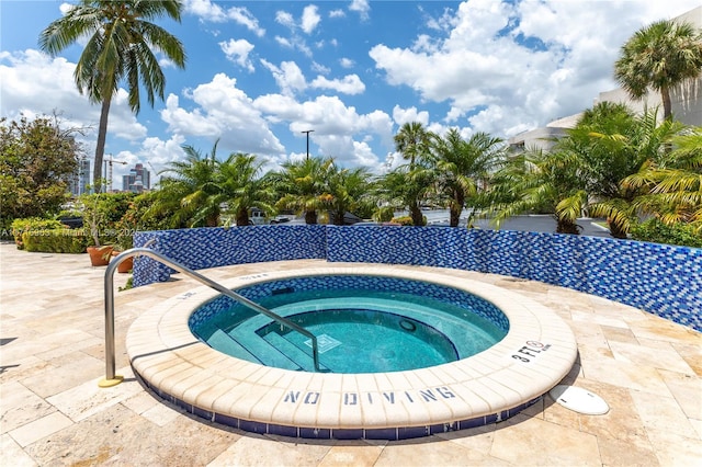 view of pool with a hot tub