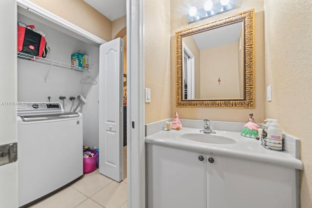 bathroom featuring tile patterned floors, washer / clothes dryer, and vanity