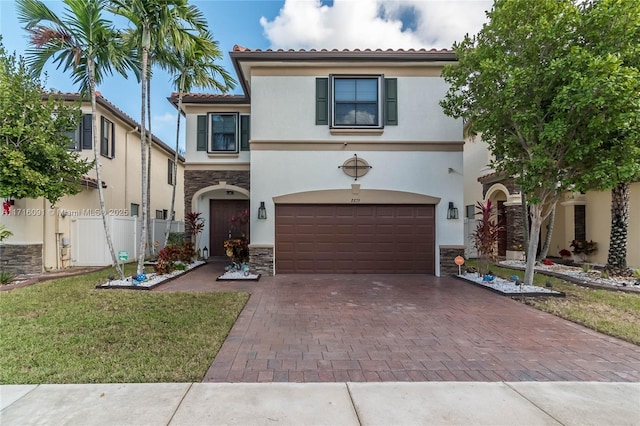 mediterranean / spanish-style house with a garage and a front yard