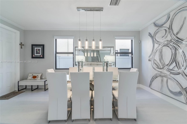 dining room with crown molding and plenty of natural light