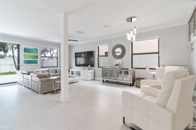 living room featuring ceiling fan and crown molding