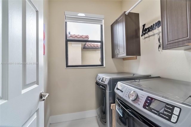 laundry room featuring cabinets and washing machine and dryer