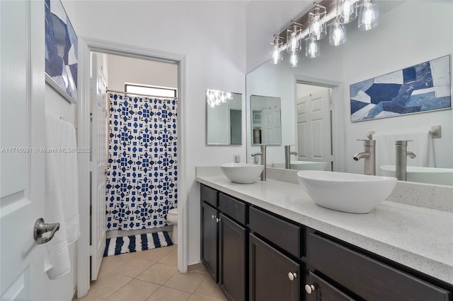 bathroom with tile patterned flooring, vanity, curtained shower, and toilet