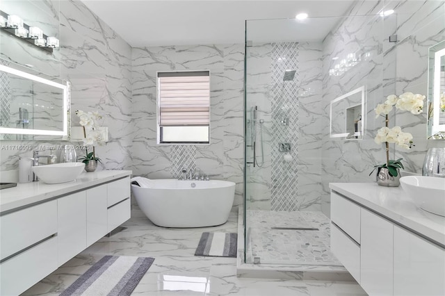 bathroom with vanity and shower with separate bathtub