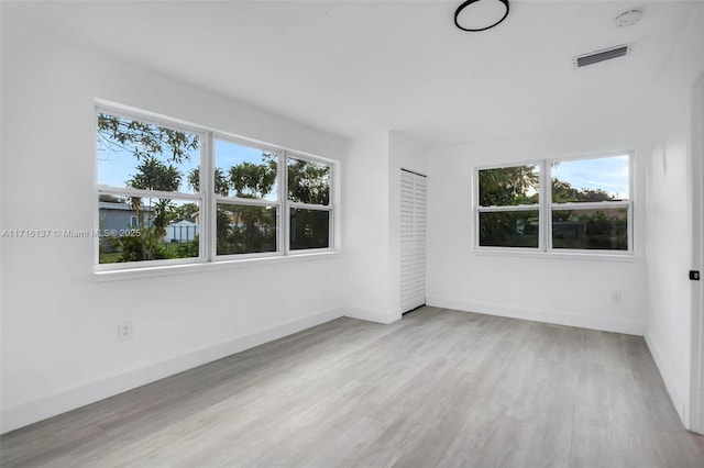 spare room featuring light hardwood / wood-style floors