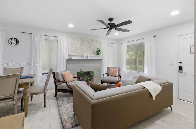 living room featuring ceiling fan and light wood-type flooring