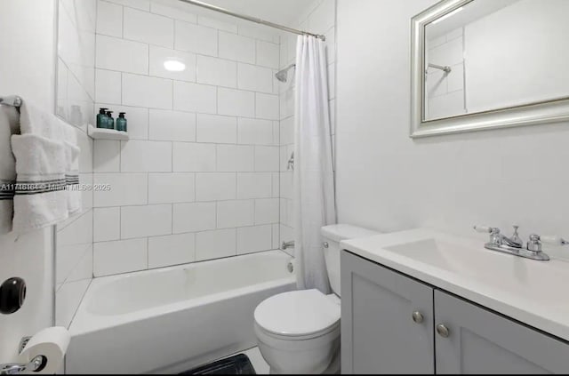 full bathroom featuring toilet, shower / bath combination with curtain, and vanity