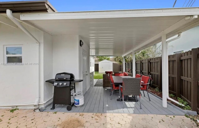 wooden deck with grilling area and a shed