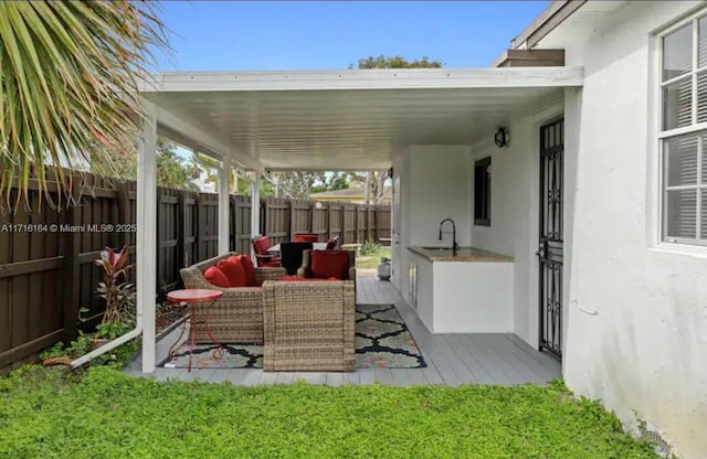 view of patio / terrace with sink and an outdoor living space