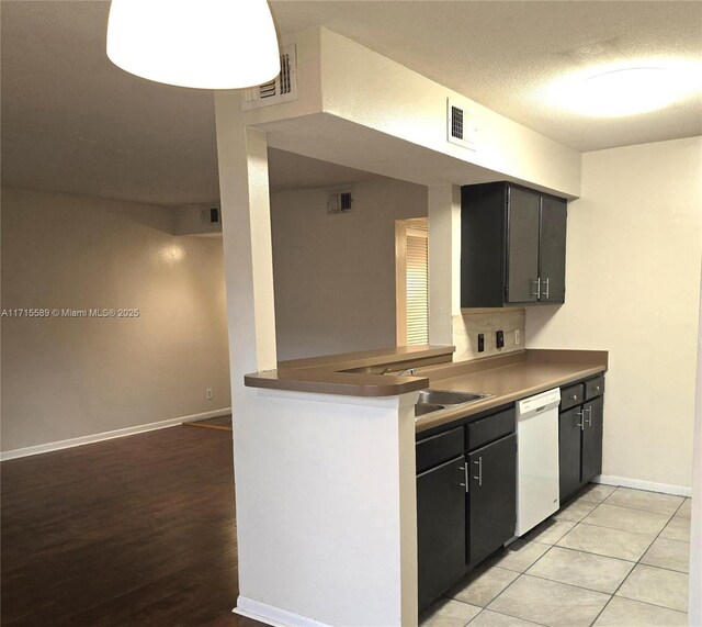 kitchen featuring white electric range oven, stainless steel fridge, a textured ceiling, and light tile patterned floors