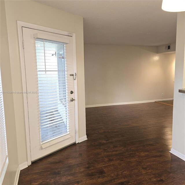 spare room featuring dark hardwood / wood-style floors