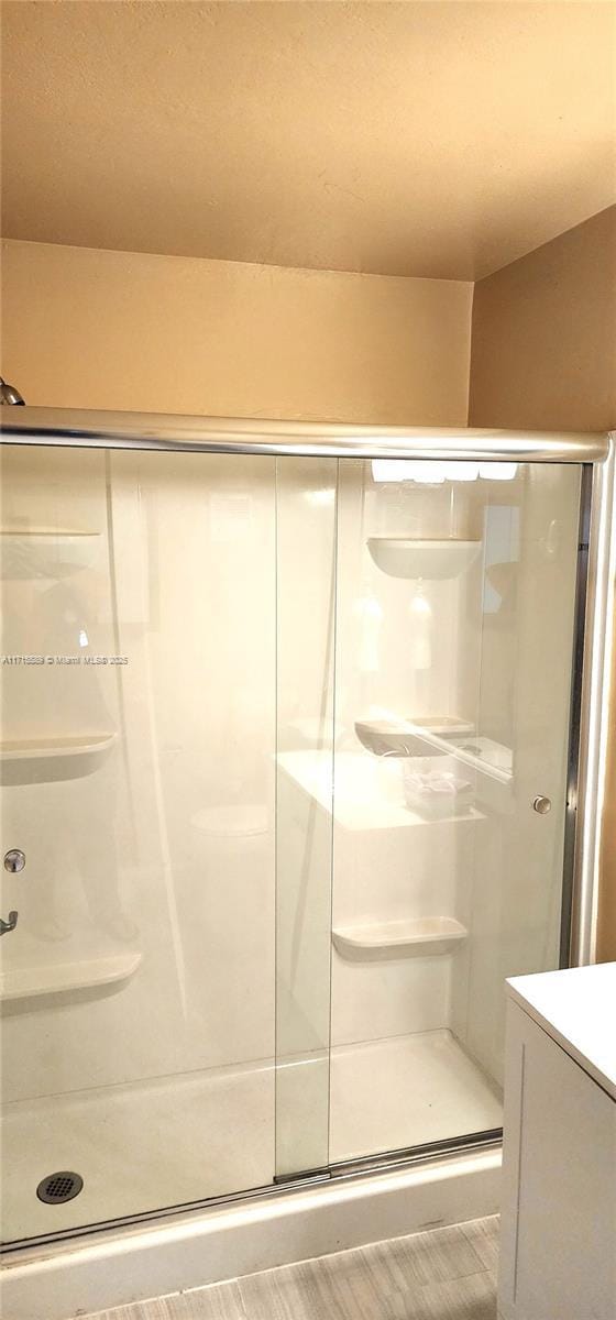 bathroom featuring a shower with door