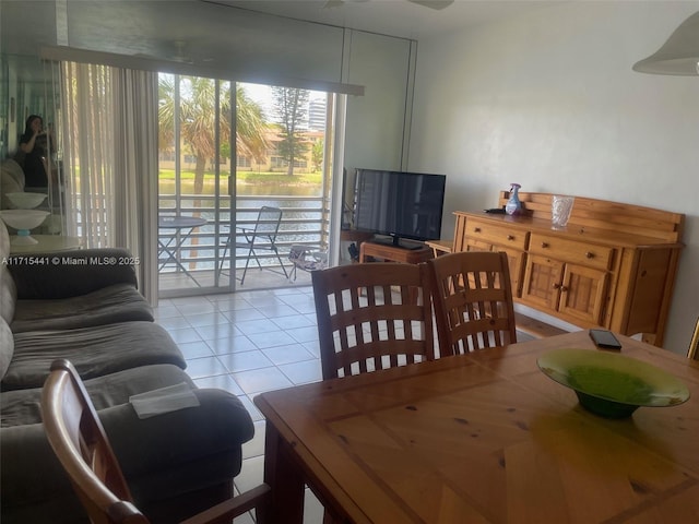 tiled dining area with ceiling fan