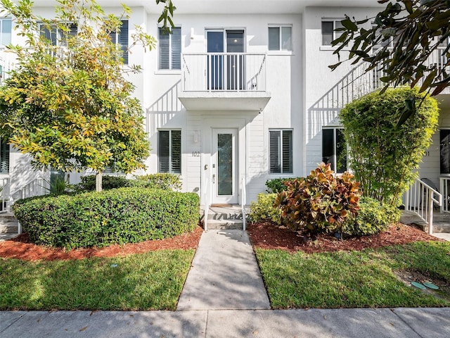 entrance to property featuring stucco siding