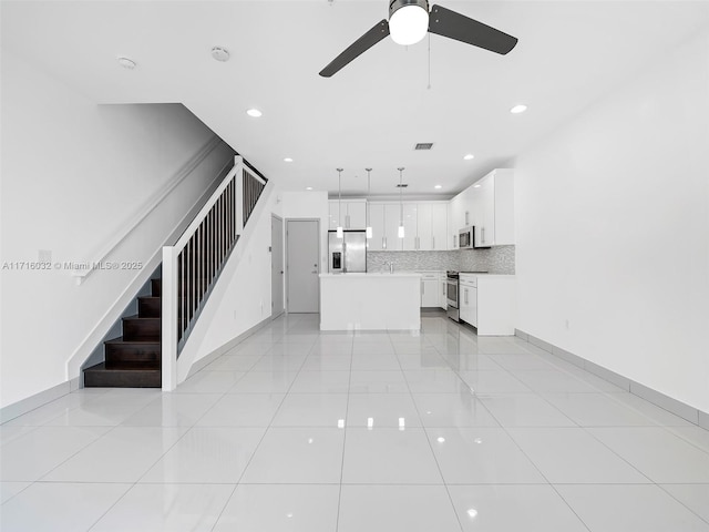 unfurnished living room with light tile patterned floors, recessed lighting, visible vents, baseboards, and stairs