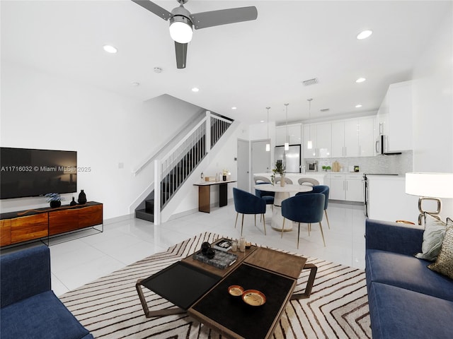 living room featuring recessed lighting, visible vents, stairway, and light tile patterned floors