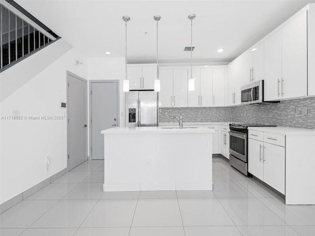 kitchen with stainless steel appliances, a sink, light countertops, and decorative backsplash