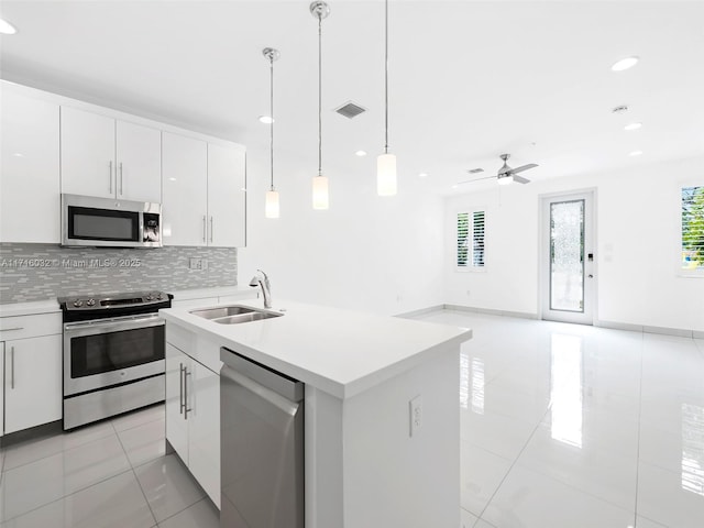 kitchen featuring a wealth of natural light, tasteful backsplash, appliances with stainless steel finishes, and a sink